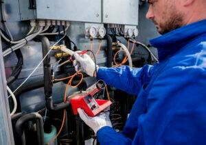 An HVAC technician repairing commercial equipment.