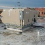 A 20-ton packaged rooftop heating and air conditioning unit just after completed installation by AireCom