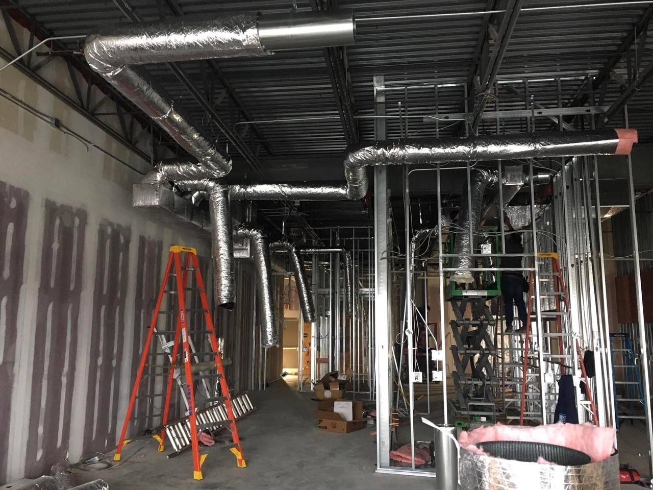 AireCom install crew working on installing ductwork for a new restaurant